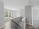 Upstairs hallway featuring luxury vinyl plank, white painted railing and access to bedrooms at 908 Sundance Dr, Gastonia, NC 28054