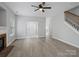 Spacious, brightly lit living room with modern flooring, a cozy fireplace, and an inviting front entrance at 908 Sundance Dr, Gastonia, NC 28054
