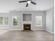 Open-concept living area with modern flooring, a cozy fireplace, and large windows for natural light at 908 Sundance Dr, Gastonia, NC 28054