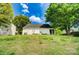 Spacious backyard featuring well-maintained lawn, mature trees, and a screened-in porch at 9711 Castle Terrace Ct, Charlotte, NC 28215