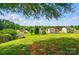 Expansive backyard view showcasing lush greenery and neighborhood homes in a suburban setting at 9711 Castle Terrace Ct, Charlotte, NC 28215