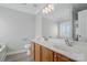 Bright bathroom boasts double sinks, a large mirror, and wood-look floors at 9711 Castle Terrace Ct, Charlotte, NC 28215