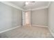 Bright carpeted bedroom with neutral walls, ceiling fan and closet at 9711 Castle Terrace Ct, Charlotte, NC 28215
