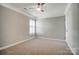 Spacious carpeted bedroom featuring a ceiling fan, neutral paint, and a window at 9711 Castle Terrace Ct, Charlotte, NC 28215