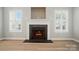 Modern fireplace surrounded by shuttered windows and hardwood floors at 9711 Castle Terrace Ct, Charlotte, NC 28215