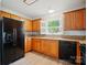 Bright kitchen features ample cabinet space and modern appliances including a black refrigerator and dishwasher at 9711 Castle Terrace Ct, Charlotte, NC 28215