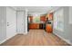 Well-lit kitchen featuring wood cabinets, black appliances, and hardwood floors at 9711 Castle Terrace Ct, Charlotte, NC 28215