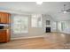 Bright and airy living area with hardwood floors, a fireplace, and kitchen view, creating a welcoming atmosphere at 9711 Castle Terrace Ct, Charlotte, NC 28215