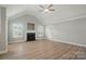 Spacious living room with vaulted ceilings, a ceiling fan, and a fireplace at 9711 Castle Terrace Ct, Charlotte, NC 28215