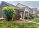 Townhome row with covered porch and brick exterior, complemented by lush landscaping and a well-manicured lawn at 102 Brandywine Ne Dr # I-1, Conover, NC 28613