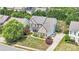 Aerial view of a distinguished brick home showcasing its manicured lawn and neighborhood at 1031 Butterburr Dr, Matthews, NC 28104