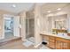 A full bathroom featuring a glass shower, double vanity, and tile flooring at 1031 Butterburr Dr, Matthews, NC 28104
