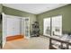 Cozy bedroom with double doors, ample natural light, and neutral-toned walls at 1031 Butterburr Dr, Matthews, NC 28104