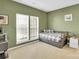 Comfortable bedroom with large windows, a daybed, and neutral carpeting, creating a serene atmosphere at 1031 Butterburr Dr, Matthews, NC 28104