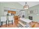 Inviting dining area featuring a stylish table and chairs with hardwood floors and modern lighting fixture at 1031 Butterburr Dr, Matthews, NC 28104