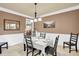 Formal dining room with wainscoting, stylish lighting, and ample seating for entertaining at 1031 Butterburr Dr, Matthews, NC 28104