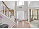 Elegant foyer with gleaming hardwood floors, high ceilings, and a view of the staircase at 1031 Butterburr Dr, Matthews, NC 28104