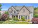 Charming two-story brick home featuring a well-manicured lawn and classic architectural details at 1031 Butterburr Dr, Matthews, NC 28104