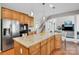 Spacious kitchen with hardwood floors, island and stainless steel refrigerator at 1031 Butterburr Dr, Matthews, NC 28104