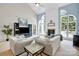 Bright living room featuring a fireplace, vaulted ceilings, and arched windows at 1031 Butterburr Dr, Matthews, NC 28104