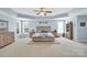 Spacious main bedroom featuring a tray ceiling, plush carpet, and comfortable furnishings at 1031 Butterburr Dr, Matthews, NC 28104