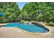 A private in-ground pool features a waterfall with a hot tub next to it at 1031 Butterburr Dr, Matthews, NC 28104