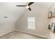 This carpeted bedroom features floating shelves and a ceiling fan for a stylish, airy feel at 108 Copes Ct, Rock Hill, SC 29732