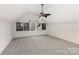 Spacious bonus room is carpeted and has a window, ceiling fan and stylish decor at 108 Copes Ct, Rock Hill, SC 29732