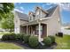 Charming two-story home with landscaped front yard, covered porch, and neutral siding and brick details at 108 Copes Ct, Rock Hill, SC 29732