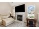 Inviting living room featuring a fireplace with TV above and large windows providing natural light at 108 Copes Ct, Rock Hill, SC 29732