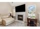 Inviting living room featuring a fireplace with TV above and large windows providing natural light at 108 Copes Ct, Rock Hill, SC 29732