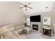 Bright living room with vaulted ceiling, a cozy fireplace, and a plush sofa, perfect for relaxation at 108 Copes Ct, Rock Hill, SC 29732