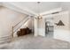 Spacious living room with carpeted floors, stairs, and modern chandelier offering a bright and airy feel at 108 Copes Ct, Rock Hill, SC 29732
