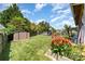 Large fenced backyard featuring lush lawn, a playground, shed and well-maintained landscaping at 11109 Amur Ct, Charlotte, NC 28262