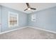Spacious bedroom featuring neutral blue walls, carpet, and large windows at 11109 Amur Ct, Charlotte, NC 28262