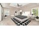 Bright bedroom with a tray ceiling, ceiling fan, and lots of natural light, creating a serene and comfortable retreat at 11109 Amur Ct, Charlotte, NC 28262