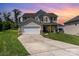 Charming two-story home featuring a two-car garage, inviting front porch and manicured lawn at 11109 Amur Ct, Charlotte, NC 28262