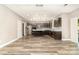 Open kitchen with stainless steel appliances, a kitchen island, and wood-look flooring at 11109 Amur Ct, Charlotte, NC 28262