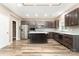 Modern kitchen featuring stainless steel appliances, a kitchen island and dark cabinetry at 11109 Amur Ct, Charlotte, NC 28262