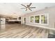 Living room with large windows, providing ample natural light and hardwood floors at 11109 Amur Ct, Charlotte, NC 28262