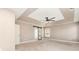 Airy primary bedroom features tray ceiling, ceiling fan, and sliding barn door leading to ensuite bathroom at 11109 Amur Ct, Charlotte, NC 28262