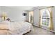 Cozy bedroom featuring plush carpeting, natural light, and a comfortable bed with decorative quilt at 1117 Yarrow St, Matthews, NC 28104