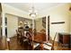 Open-concept dining area with decorative columns, hardwood floors, and views into the living room at 1117 Yarrow St, Matthews, NC 28104