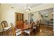 Bright dining room showcasing a wooden hutch, chandelier, and hardwood floors at 1117 Yarrow St, Matthews, NC 28104