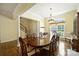 Elegant dining room featuring hardwood floors, decorative columns, and a large window with natural light at 1117 Yarrow St, Matthews, NC 28104