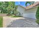 Side view of a home with an attached two-car garage and a long driveway at 1117 Yarrow St, Matthews, NC 28104