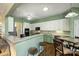 Bright eat-in kitchen featuring white cabinets and a breakfast bar with seating at 1117 Yarrow St, Matthews, NC 28104