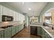 Well-lit kitchen with modern appliances, a built-in desk, and ample counter space at 1117 Yarrow St, Matthews, NC 28104