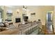 Cozy living room with a fireplace, large windows, and plush furniture at 1117 Yarrow St, Matthews, NC 28104