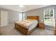 Comfortable main bedroom with carpet, neutral paint, and bright windows to bring in natural light at 1117 Yarrow St, Matthews, NC 28104